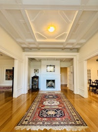 a large living room with hardwood floors and a rug