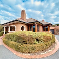 a brick home with a circular driveway